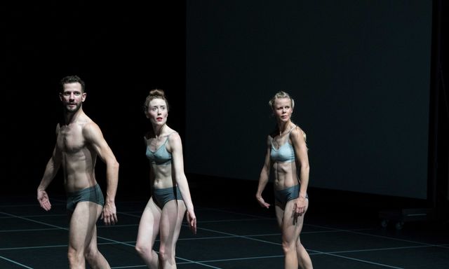 Three dancers in underwear focussing on something