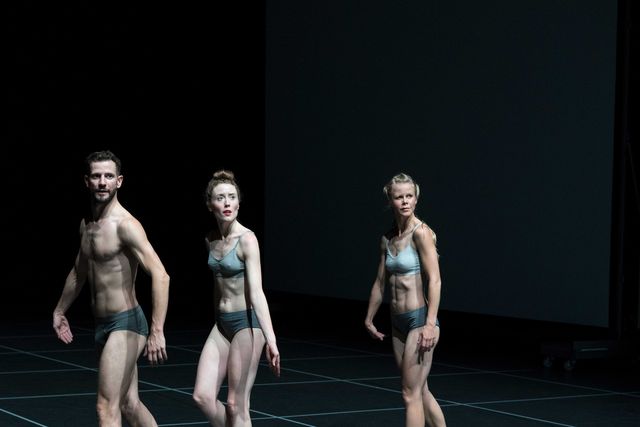 Three dancers in underwear facing the audience