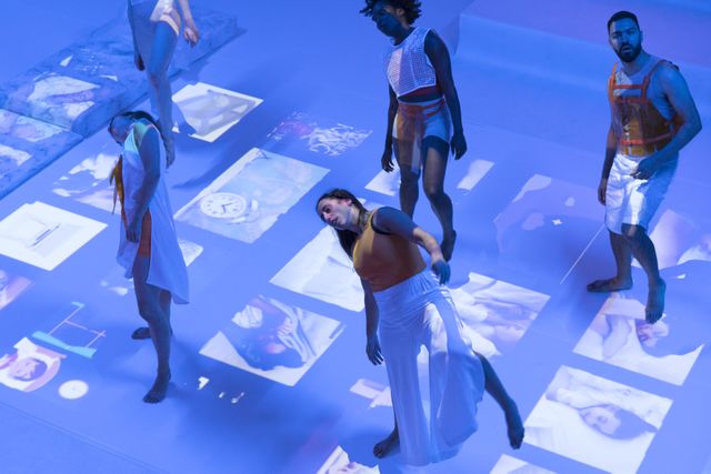Group of performers dancing in a projection
