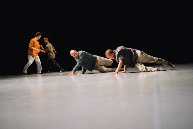 Two duos of male performers on stage