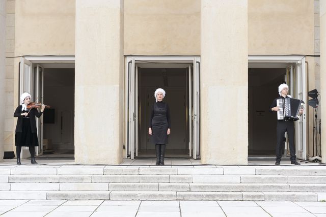 Three musicians in front of Festspielhaus Hellerau