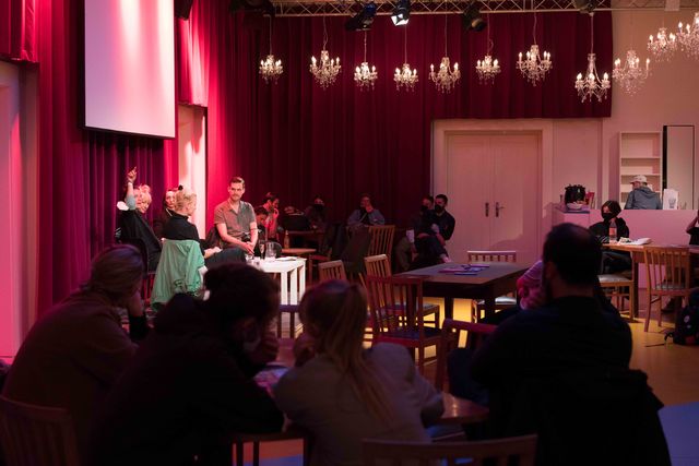 Audience members watching an artist talk